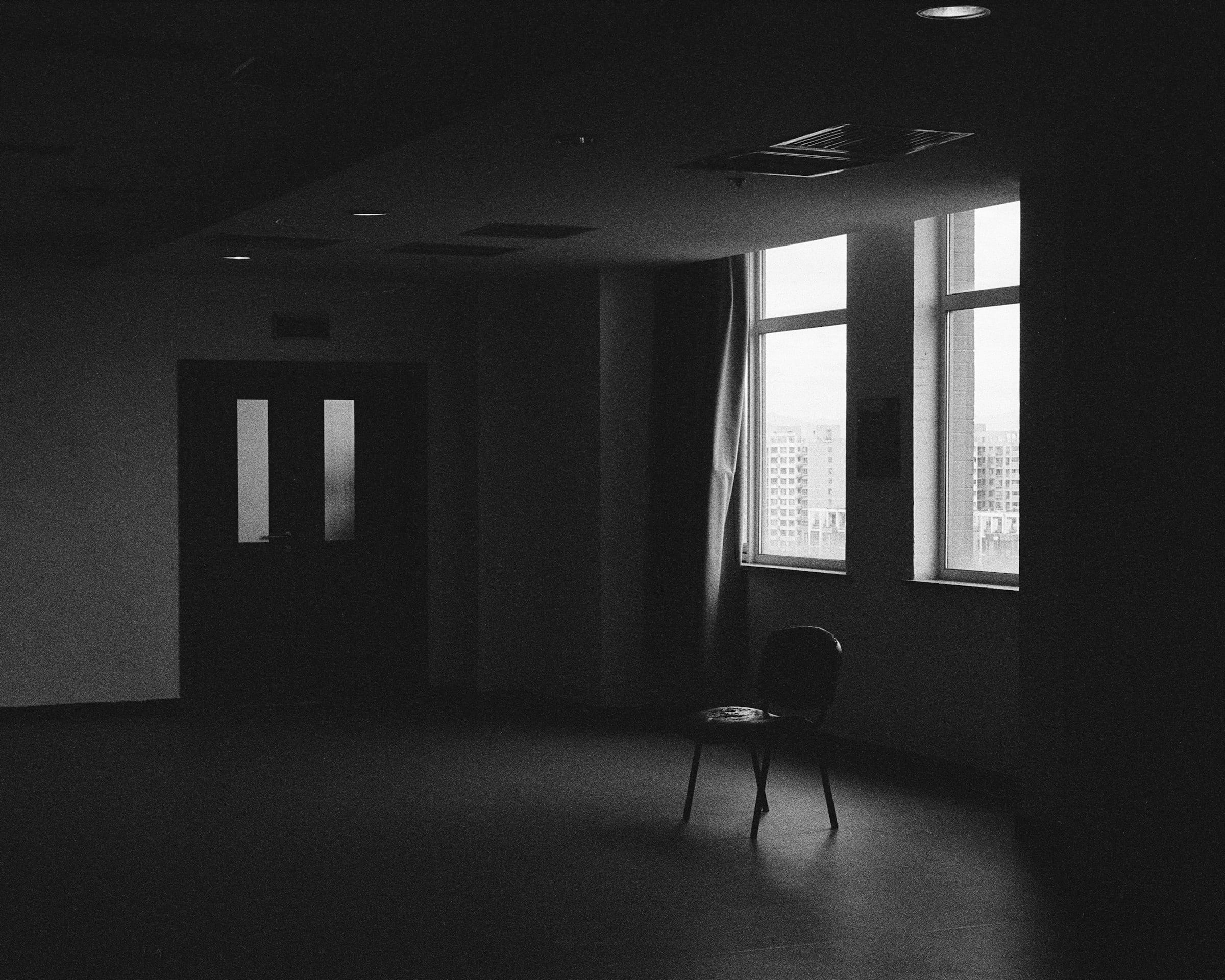 A single chair in an empty light-filled room, an invitation to start a conversation with Moweb