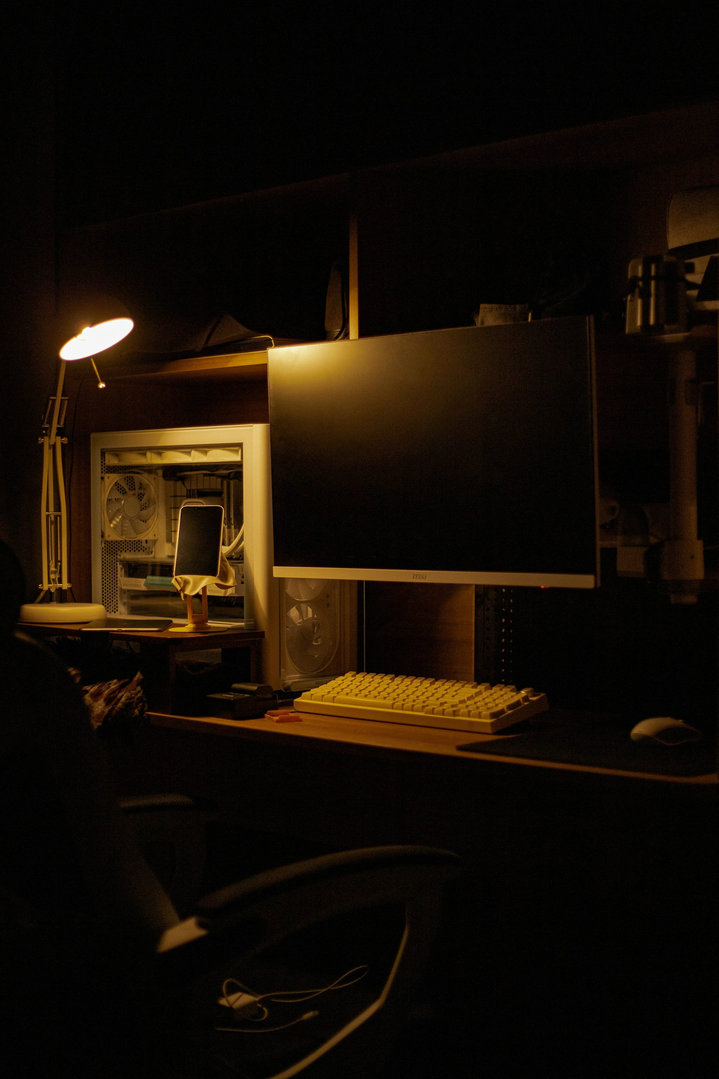 A workspace lit only by warm ambient light at night, where enterprise AI software products are built