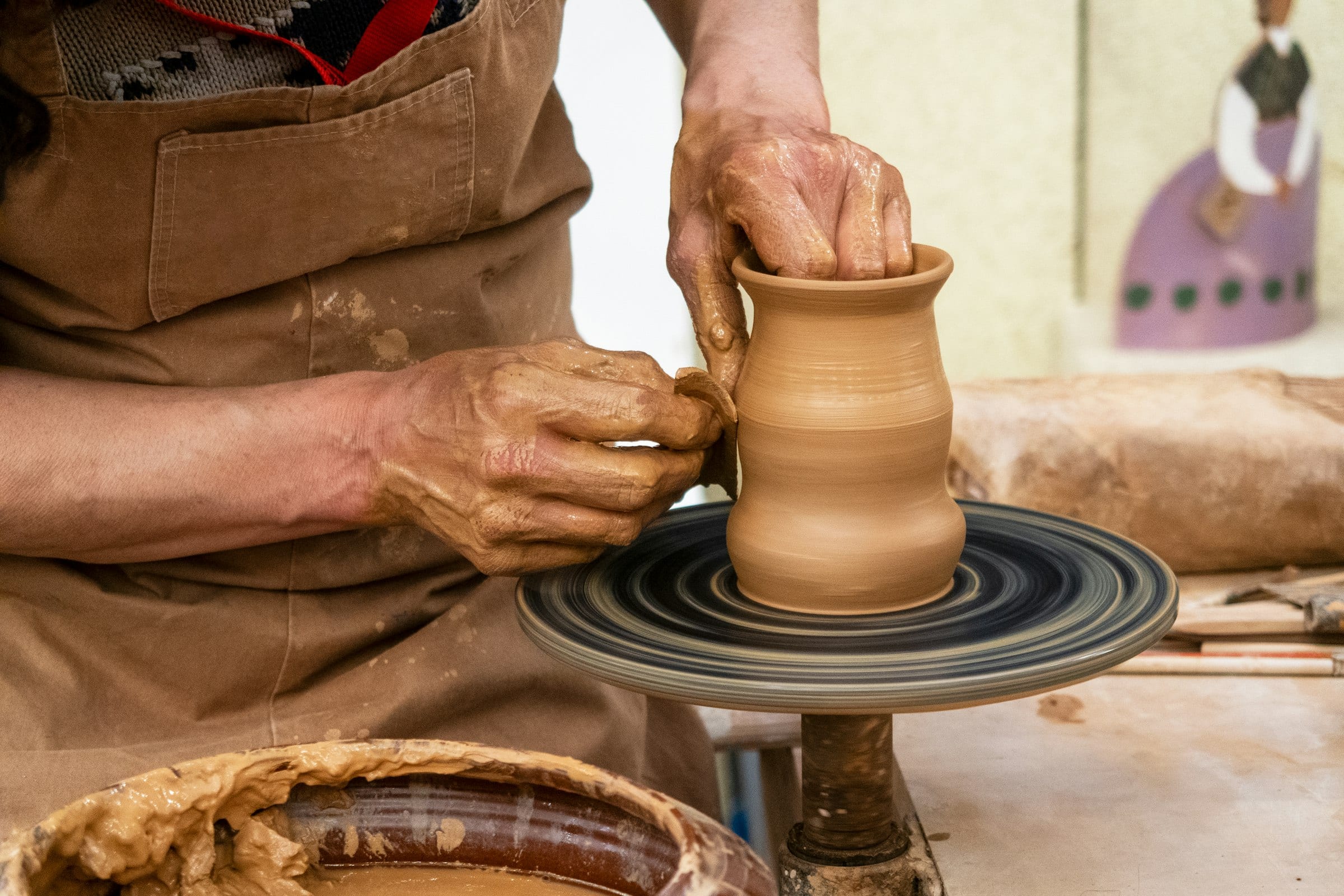A potter's hands at the wheel, the artisan craft behind premium web and mobile development